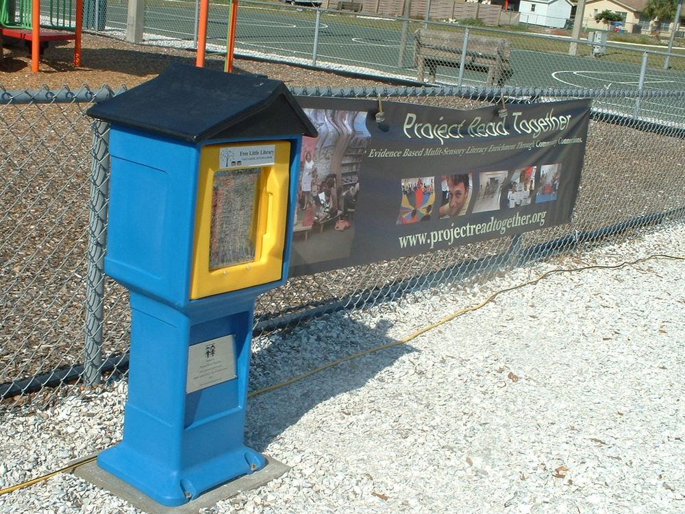Little Free Library with 'Take a book, return a book' signage